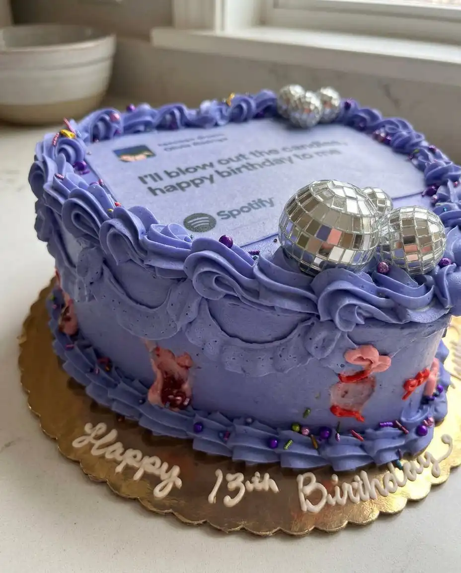 Olivia Rodrigo Cake 14 A slice of purple cake showing the four internal layers