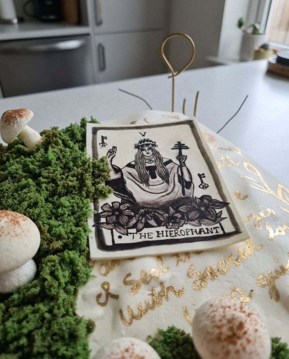 Spreading black chocolate frosting onto a layered cake