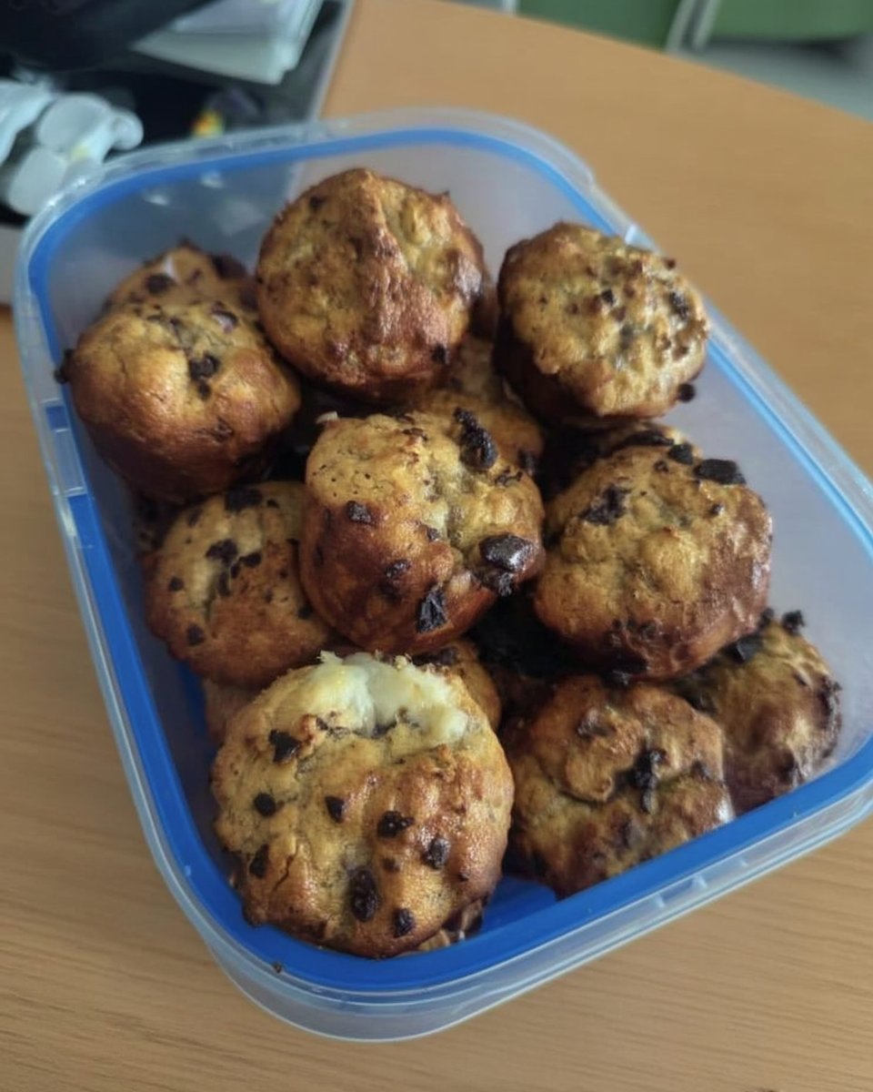 A three-layer chocolate cake with pink strawberry frosting and a dark chocolate ganache drip
