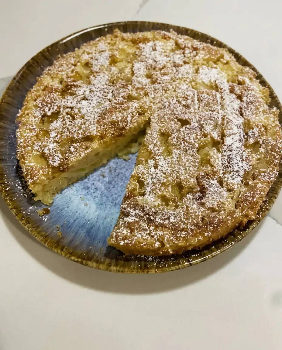 Warm apple cake served with a scoop of vanilla ice cream
