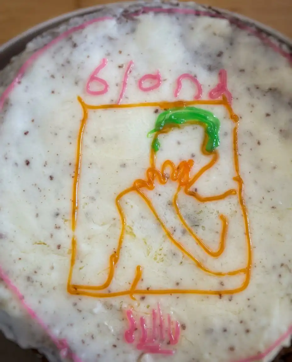 A close up shot of a slice of Frank Ocean Cake showing the blue and teal interior layers.