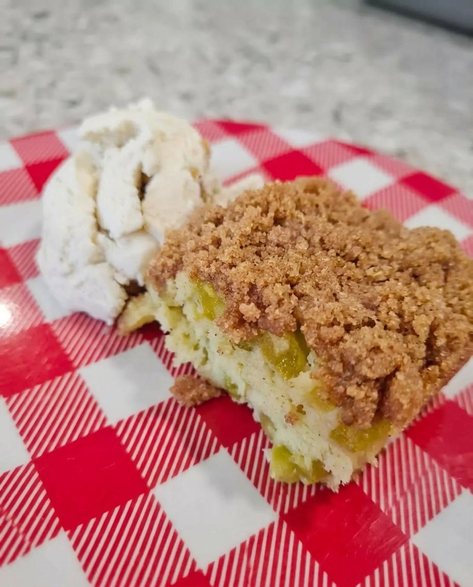 Fresh rhubarb stalks and strawberries next to a box of white cake mix