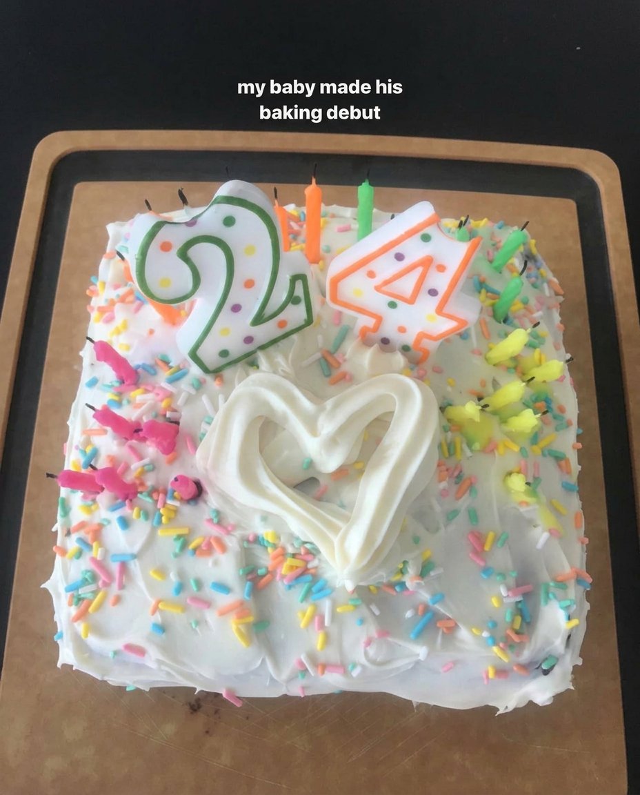 Frank Ocean Cake 13 A hand kneading dark modelling chocolate to make palm tree trunks for a cake.