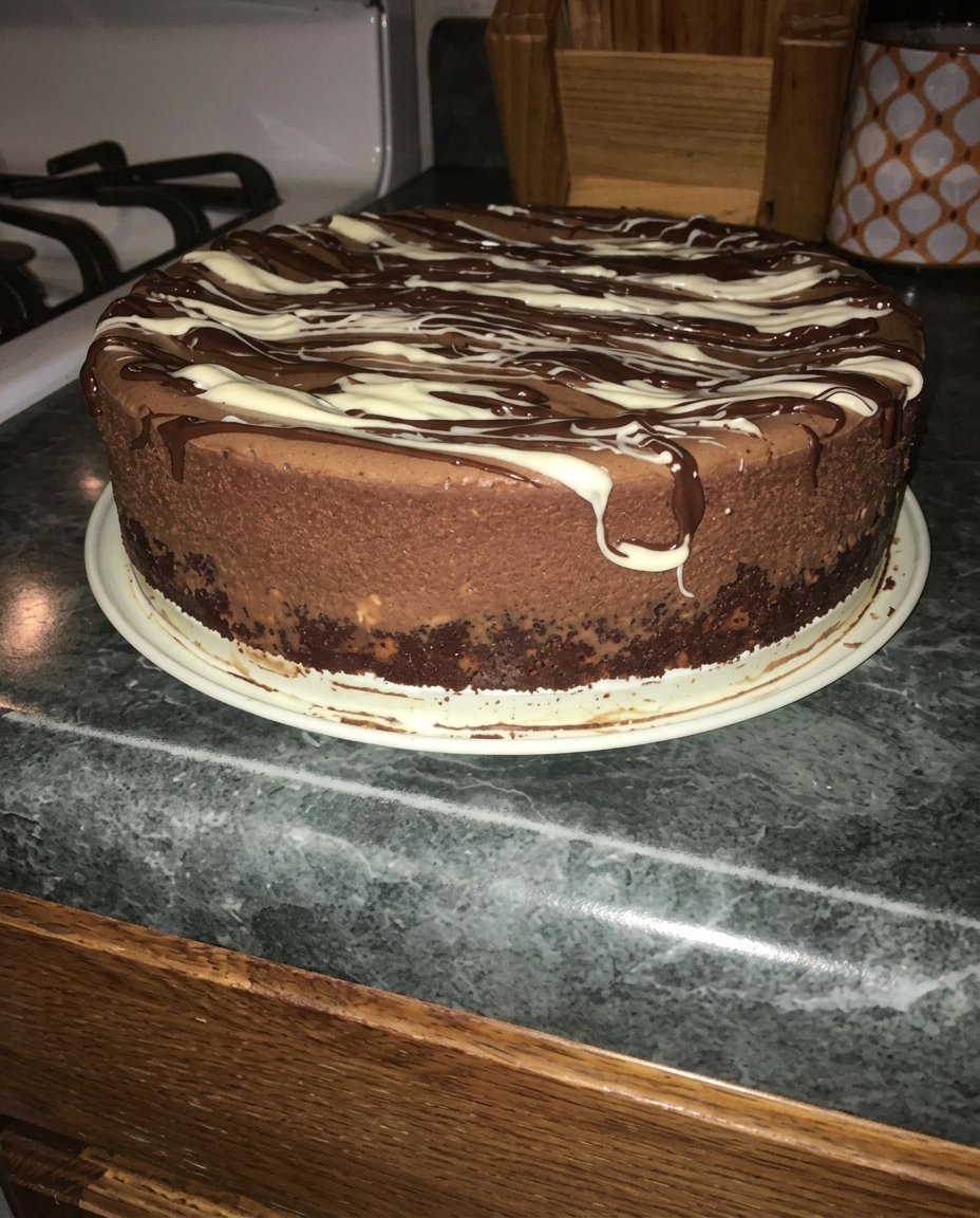 Electric mixer whipping chocolate cream into soft peaks