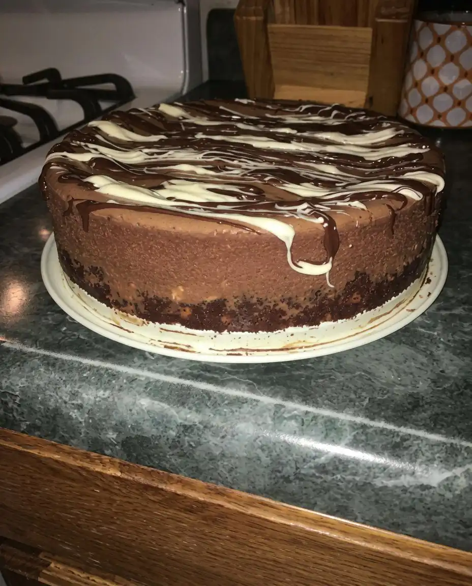 Electric mixer whipping chocolate cream into soft peaks