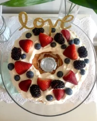 A light and airy angel food cake layered with white marshmallow cream and fresh red and blue berries.