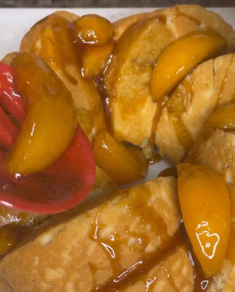 Swirling peach mixture into pound cake batter in a Bundt pan