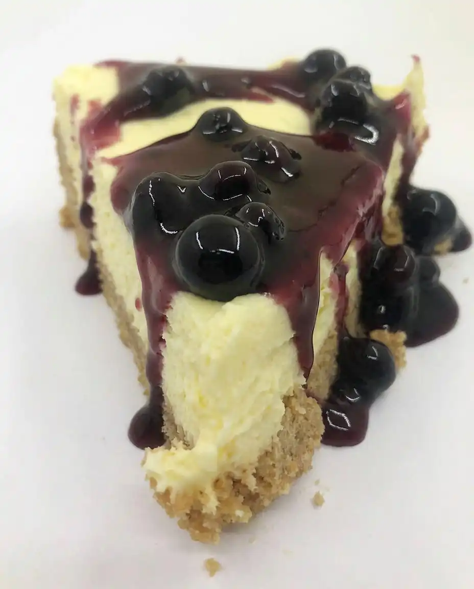 Ingredients like graham crackers, lemon pudding, and blueberry pie filling on a wooden table