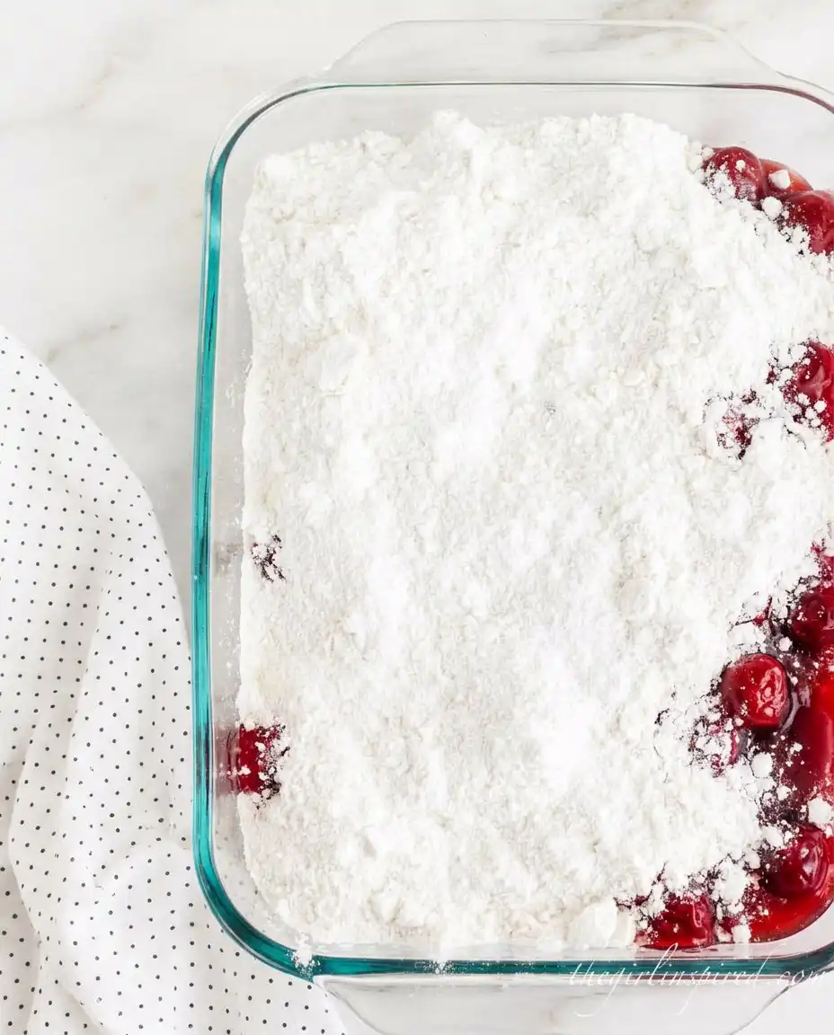 Cans of strawberry filling cake mix cream cheese and butter on a counter