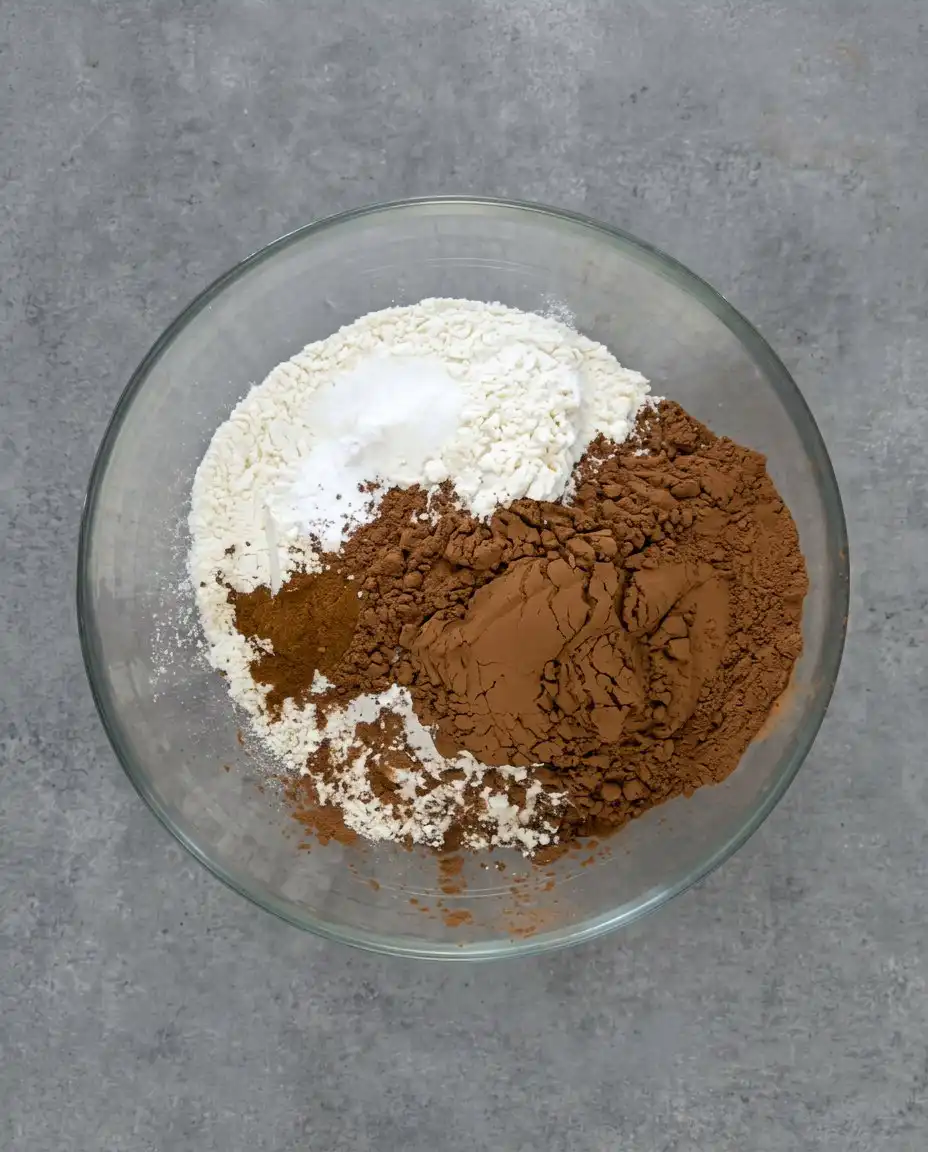 Ingredients for chocolate zucchini cake including cocoa, zucchini, and cinnamon