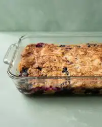 A warm Blackberry Dump Cake with Cake Mix showing bubbling purple fruit and golden crust.