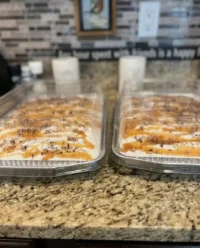 A close up slice of chocolate caramel toffee crunch cake with whipped topping
