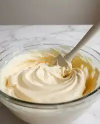Fluffy vanilla mousse cake filling ready for layering