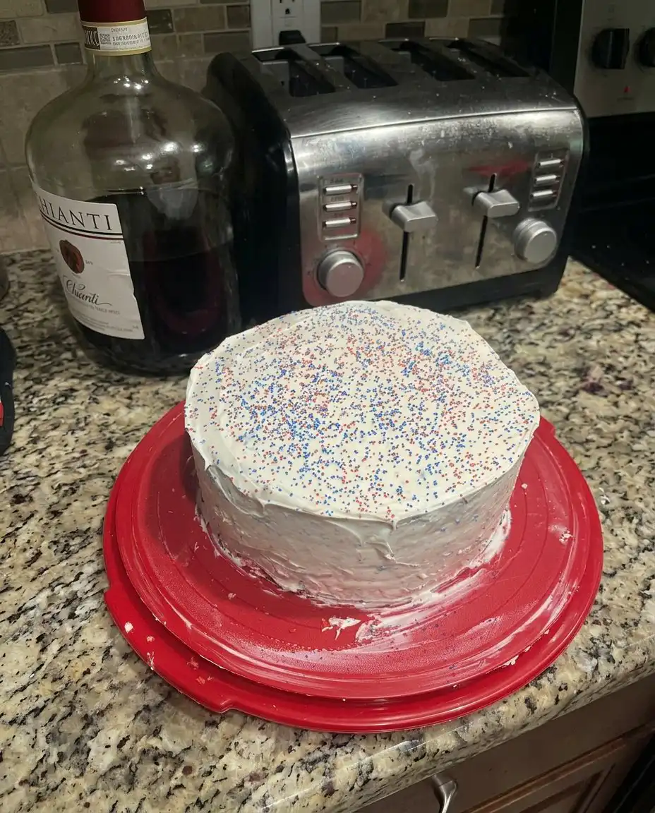 Using a biscuit cutter to create the center rings for the flag cake layers.