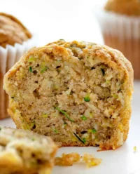 Freshly baked banana zucchini muffins sitting on a wire cooling rack