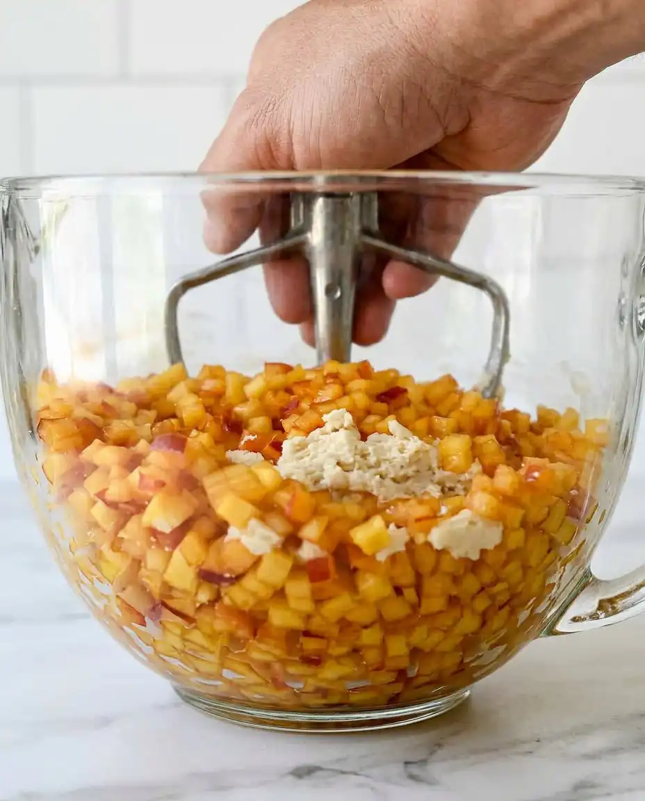 Fresh peaches and honey on a kitchen counter with flour and sugar