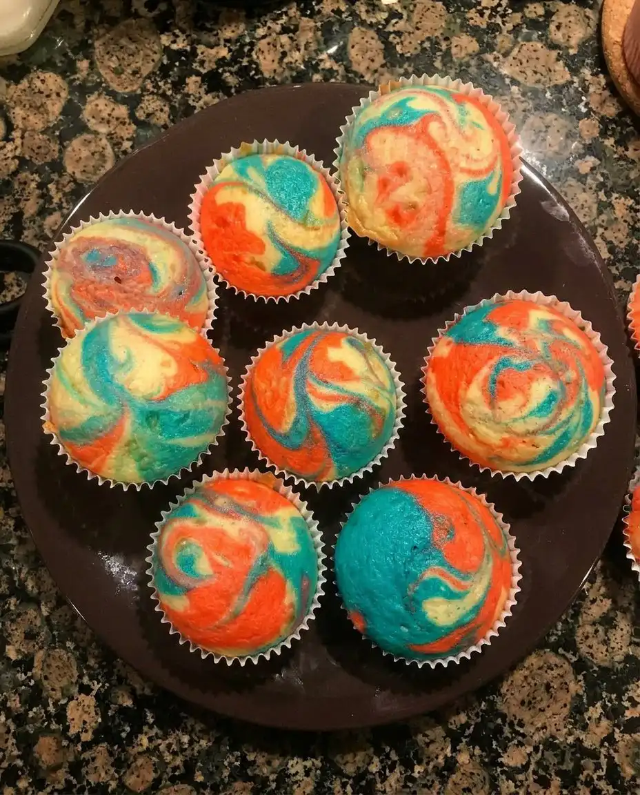Piping frosting onto chocolate cupcakes