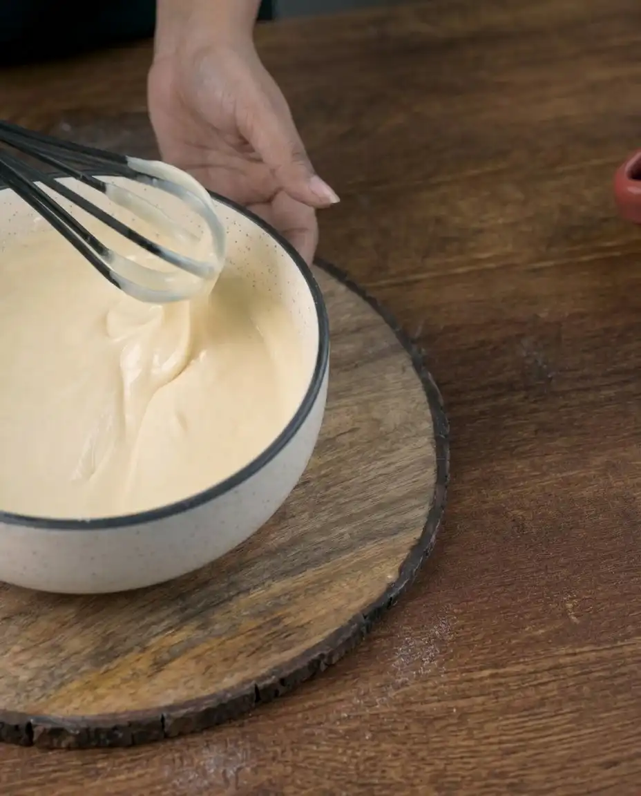 Bowls of flour, yogurt, strawberries, and vanilla essence for a Strawberry Vanilla Cake.
