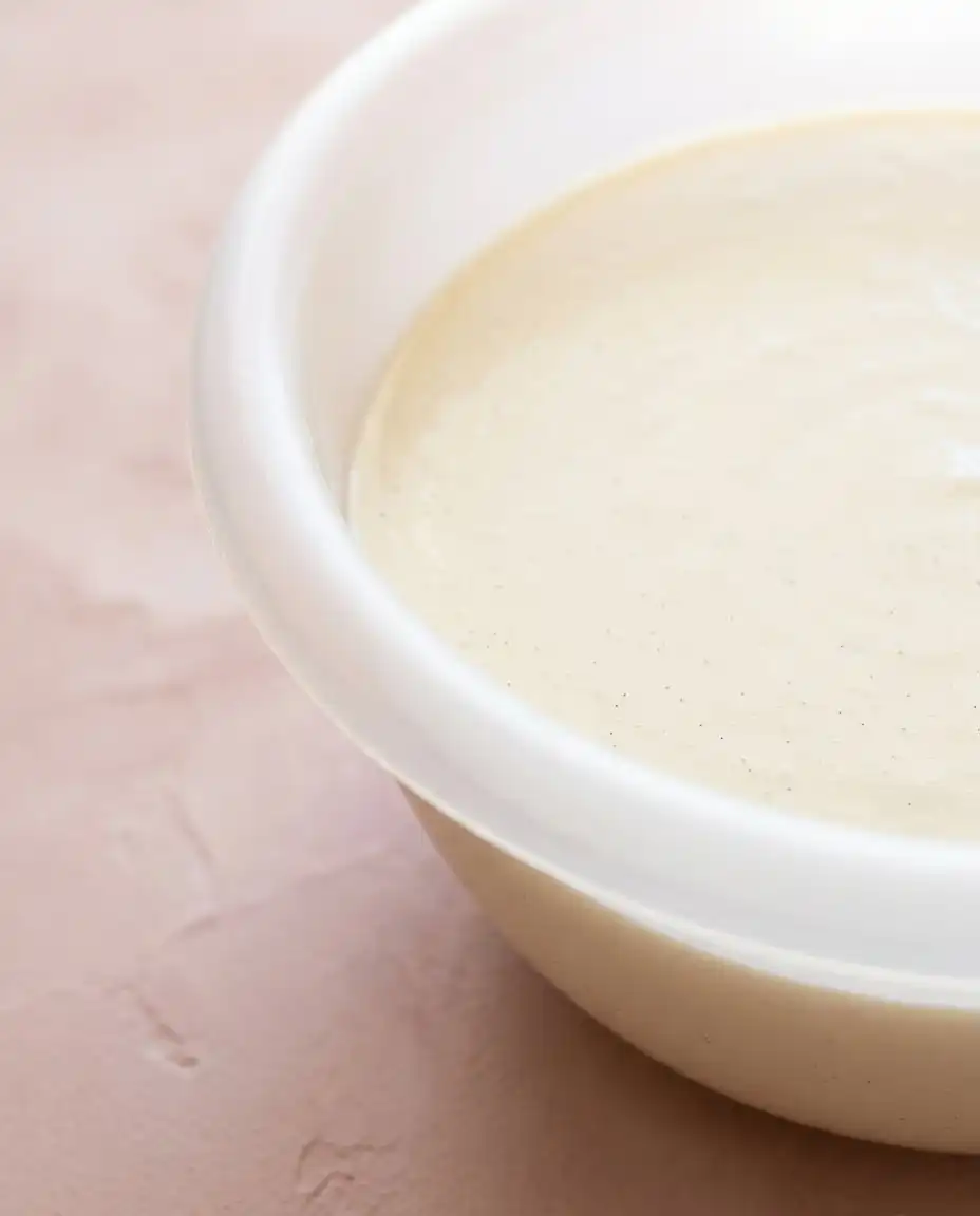 Bowls of flour, butter, heavy cream, and pink peach powder for a Classic Peach Pound Cake.