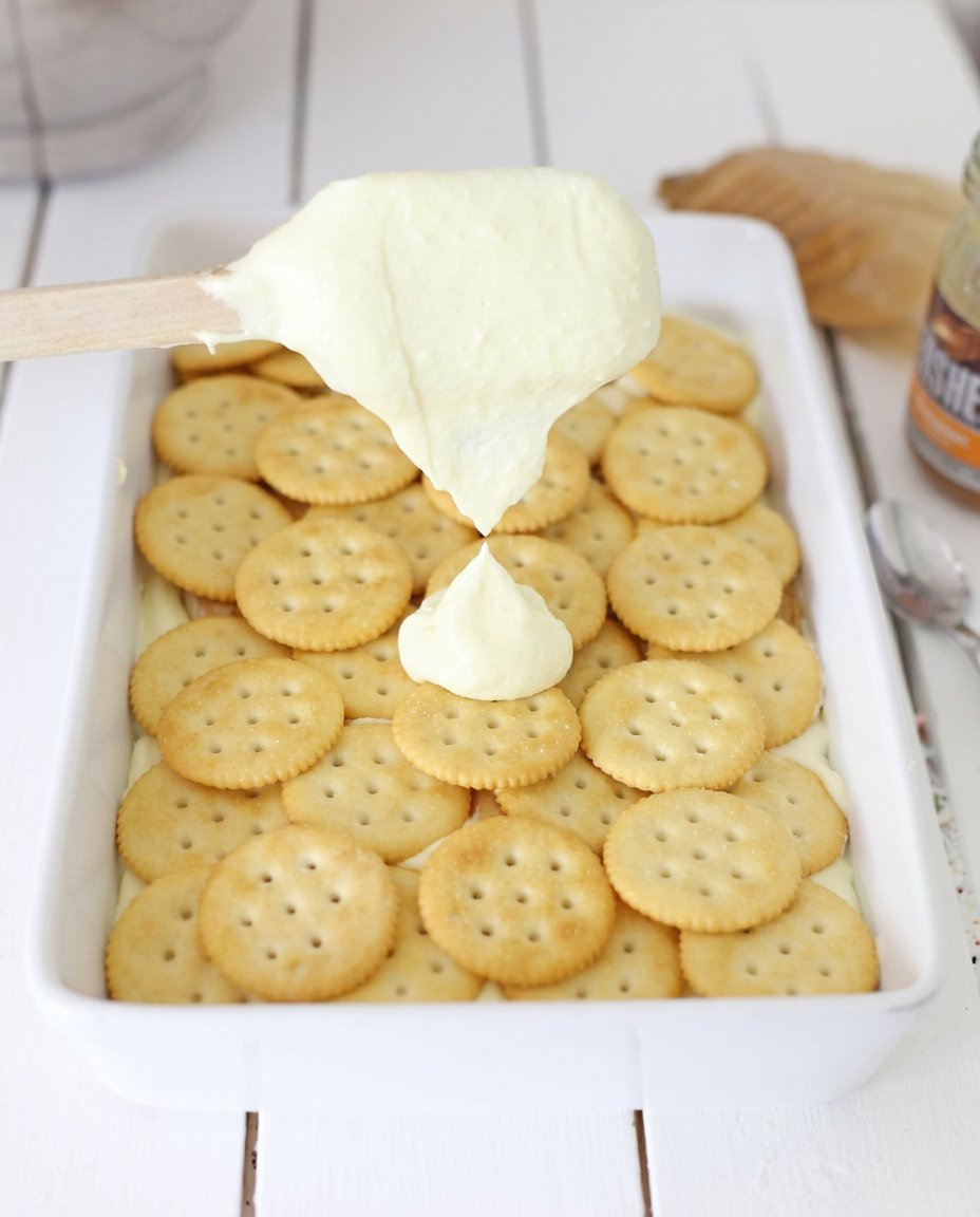 Ritz crackers, cream cheese, heavy cream, and sugar on a kitchen counter