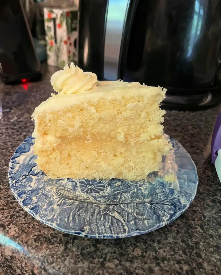 Whisking together the yellow lemon velvet cake batter in a glass bowl