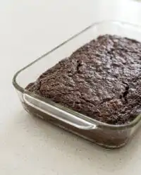 A freshly baked Old-Fashioned Chocolate Zucchini Cake resting in a 9x13 baking pan.