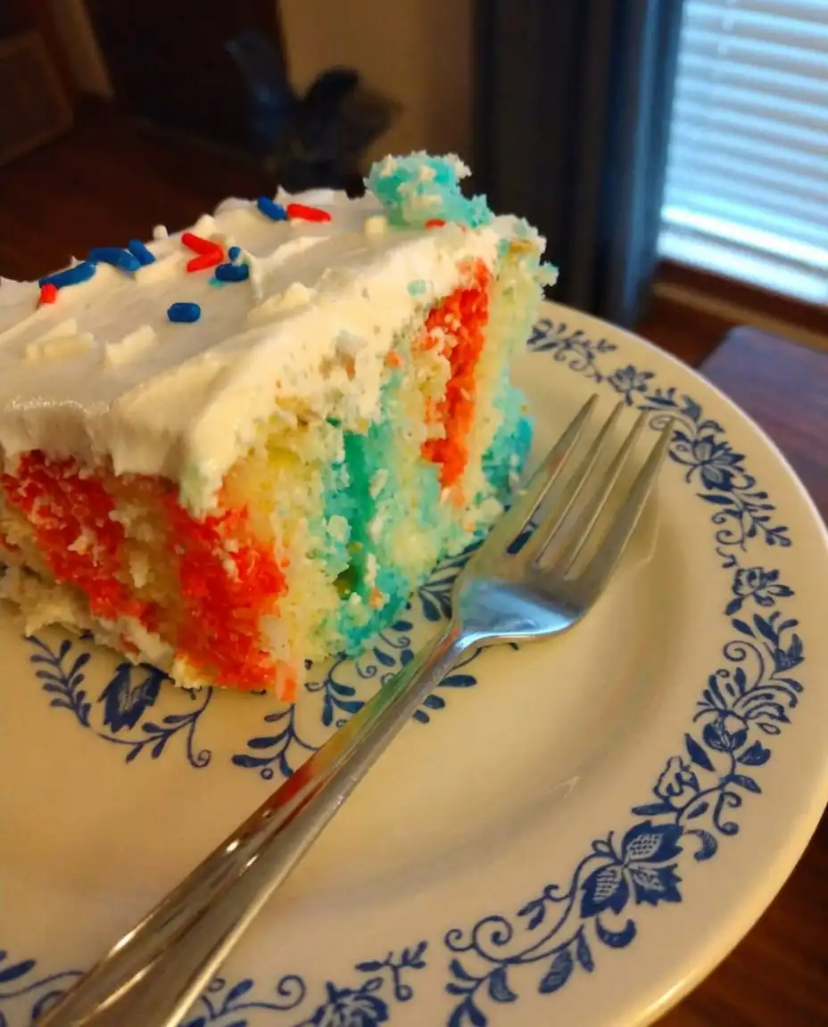 Close up of whipped topping with red and blue swirls and sprinkles