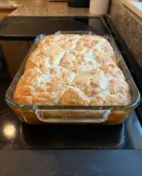 A golden brown Patti Labelle’s Peach Cobbler in a rectangular baking dish.