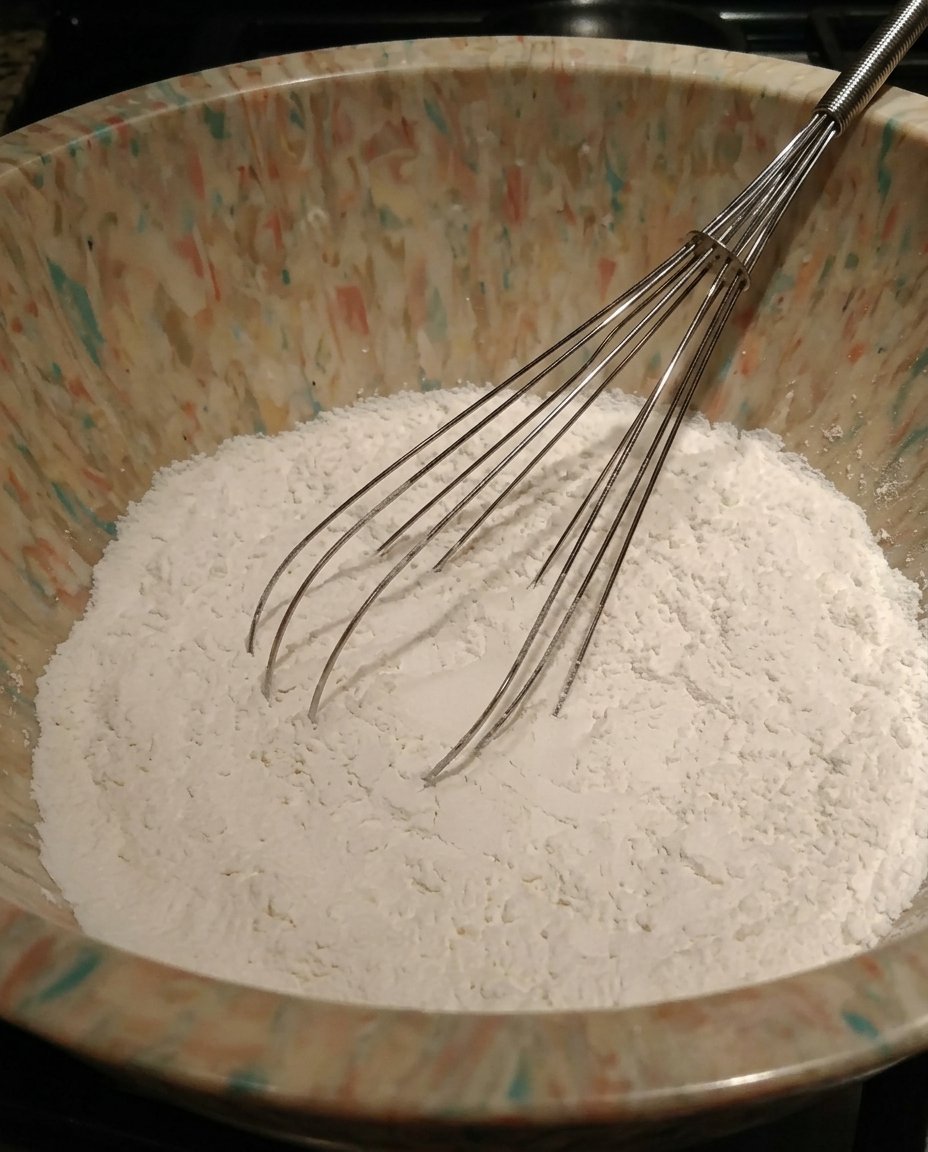 Bowls of flour sugar peaches and oats for muffins