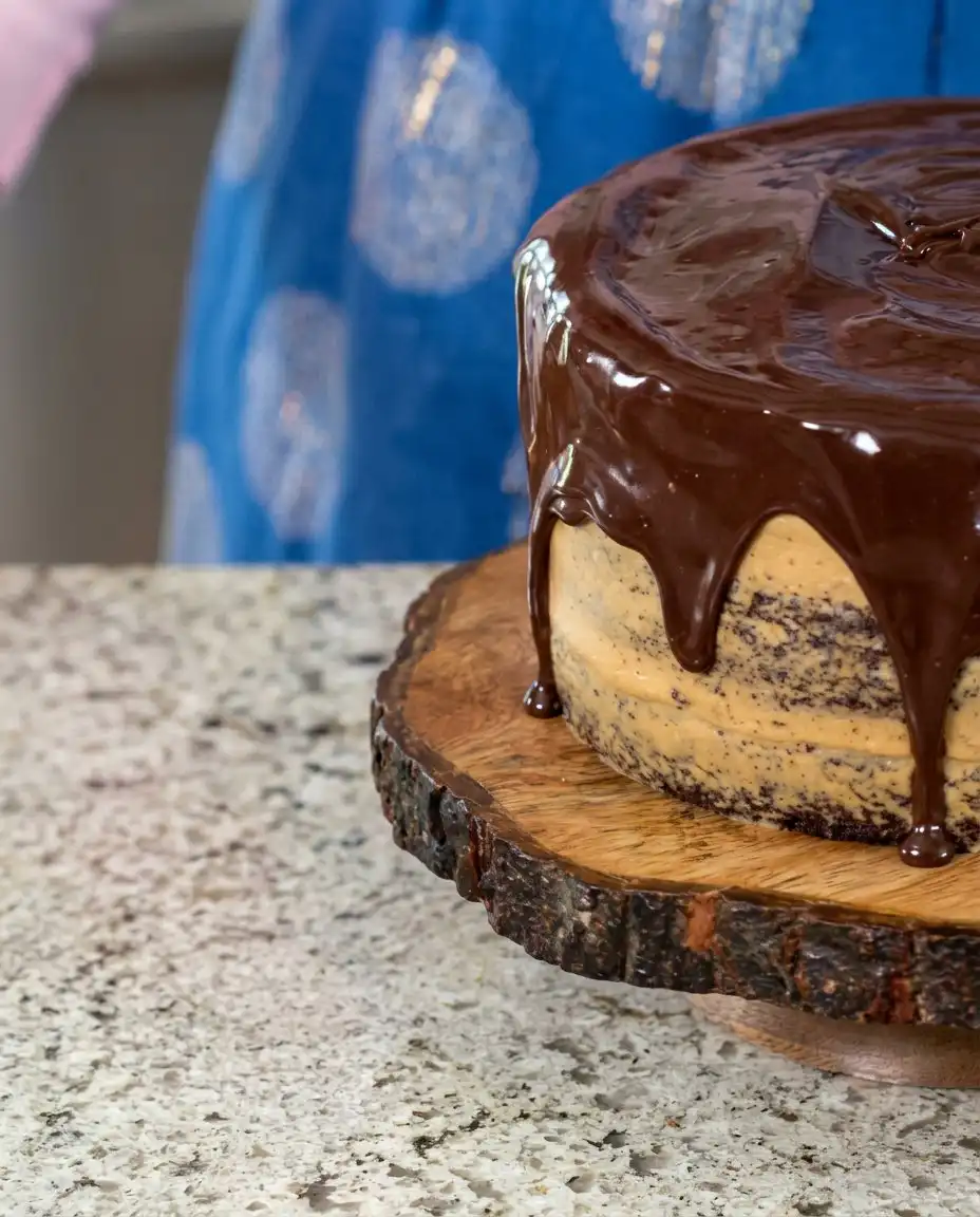 Creamy peanut butter frosting being whipped in a glass bowl