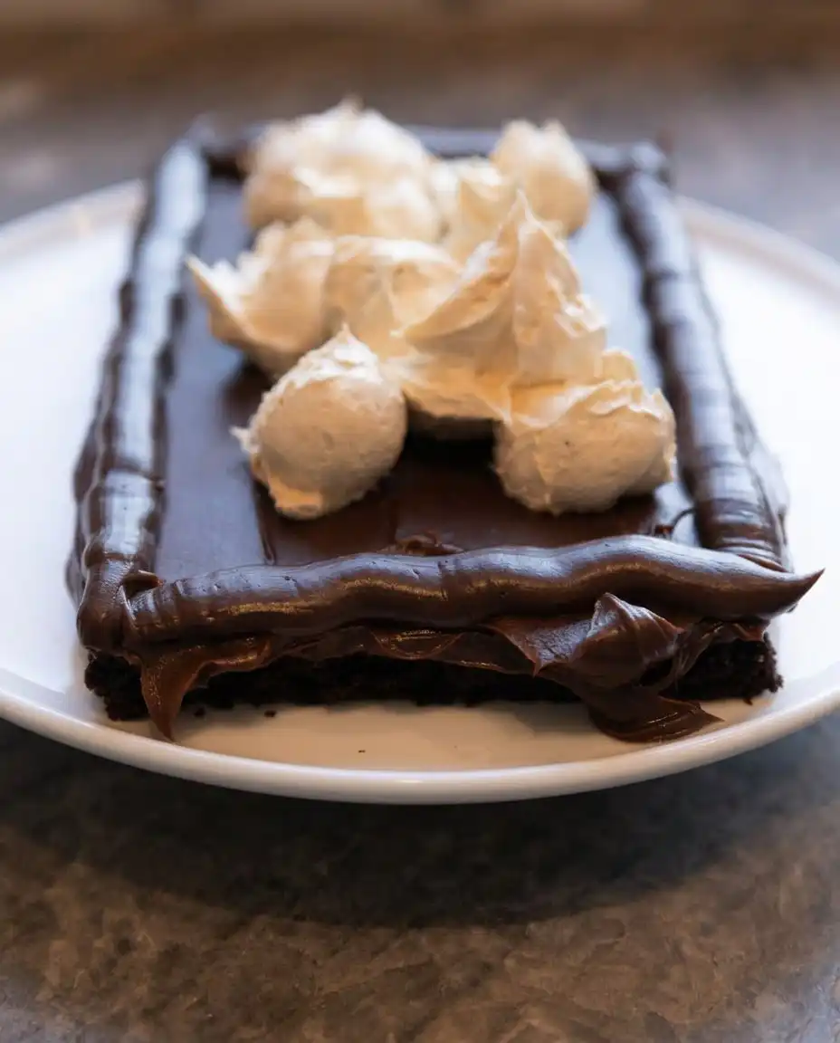 The completed Peanut Butter Fudge Cake served on a white platter with open sides