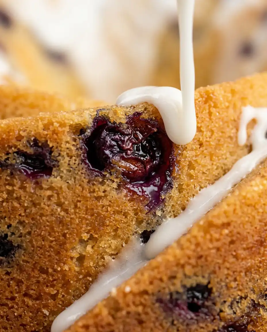 A hand pitting fresh cherries for a cherry amaretto bundt cake
