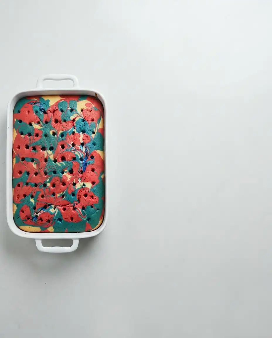 Boxed cake mix, instant pudding, milk, cream, and food coloring on a kitchen counter