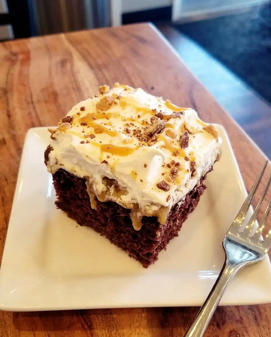 Using a wooden spoon to poke holes in a baked chocolate cake