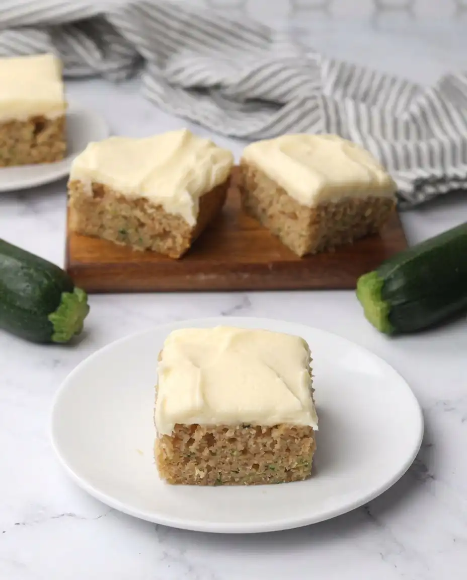 A single slice of Zucchini Bars served on a vintage china plate with a fork.
