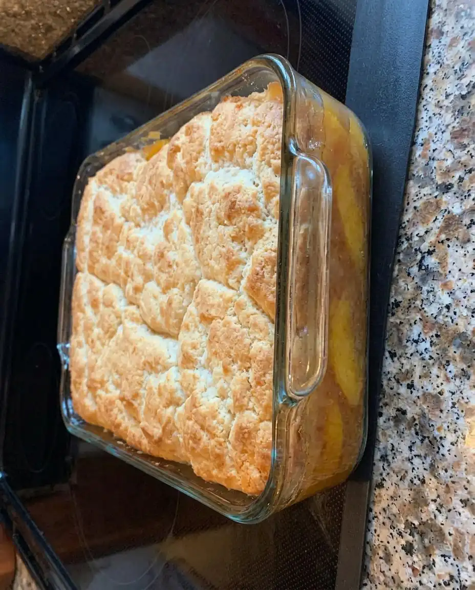 A scoop of Patti Labelle’s Peach Cobbler served with vanilla ice cream.