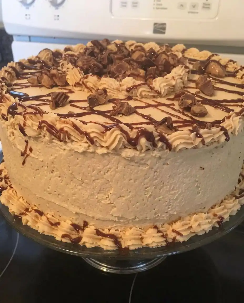 Old-Fashioned Peanut Butter Cake 14 A thick slice of peanut butter cake on a white plate next to a glass of milk.