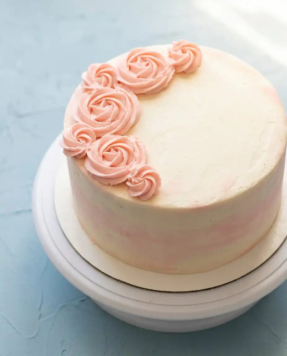 Rose Water Layer Cake 16 A single slice of rose water layer cake served on an heirloom china plate with a fork.