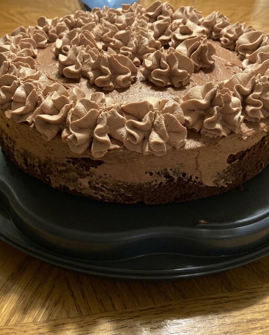 Two slices of chocolate mousse cake served with two cups of coffee