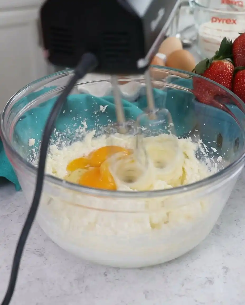 Ingredients for strawberry shortcake cake including fresh berries and cream