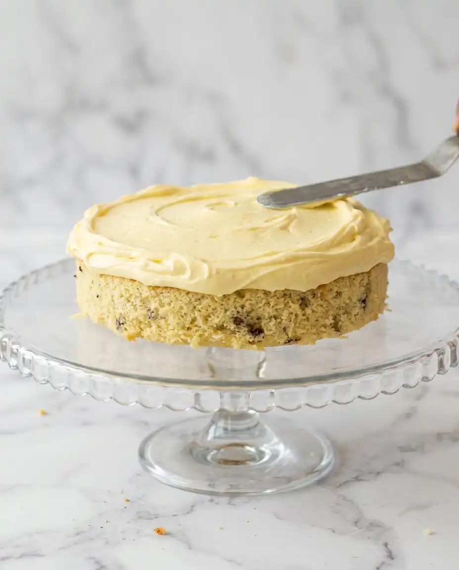 Toasting chopped pecans in a pan for Three-Layer Italian Cream Cake
