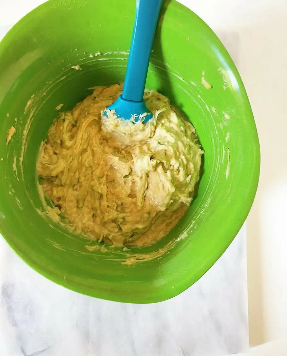 Basic ingredients for zucchini coffee cake muffins including flour, zucchini, and butter