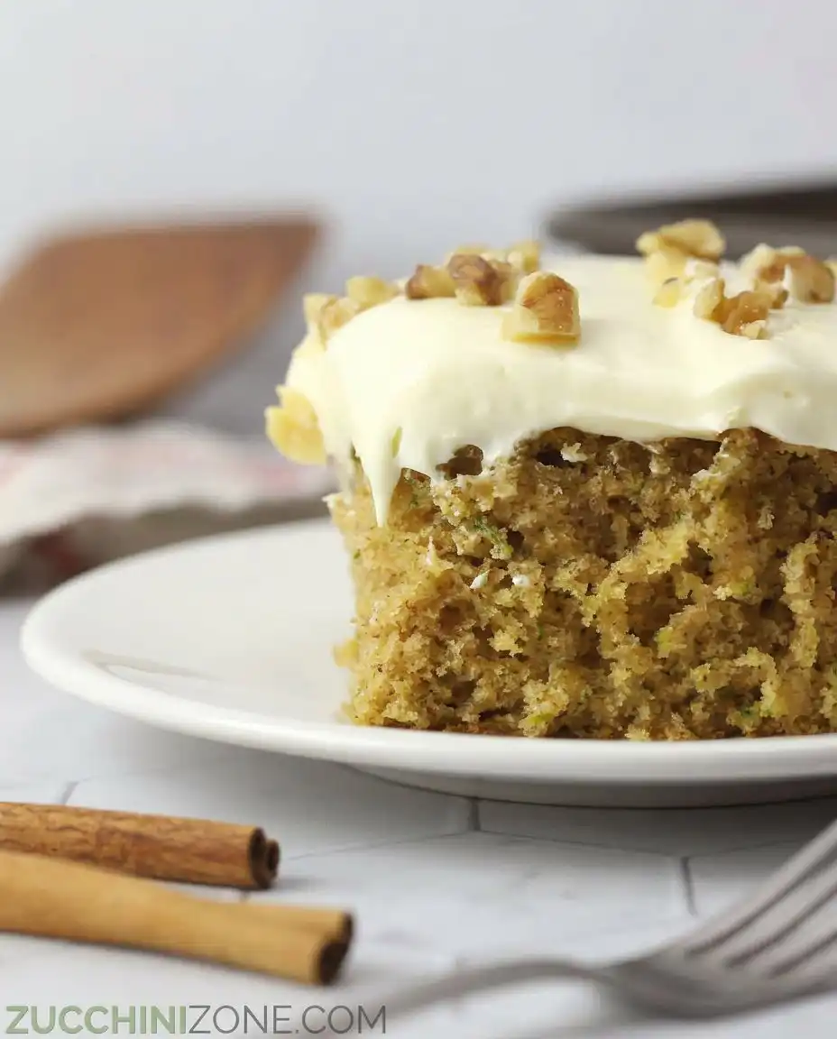A square of zucchini spice cake with walnuts on top