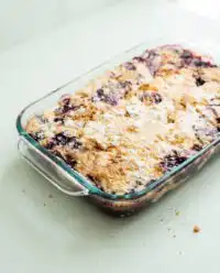 Warm Blackberry Dump Cake with Butter Pecan Cake Mix served in a glass baking dish.