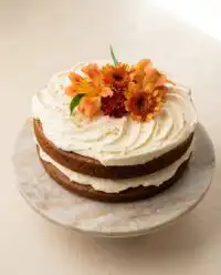 A slice of cozy homemade brown butter pumpkin cake with rich caramel layers.