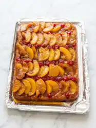 Warm peach upside down cake with white box cake mix in a cast iron skillet