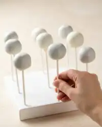 Homemade Oreo Cake Pops lined up on a baking sheet lined with parchment paper
