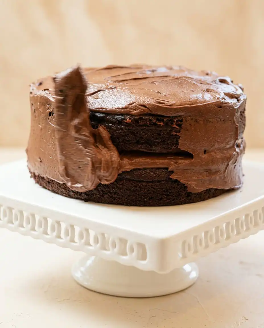 Gently spooning flour into a measuring cup to bake a fluffy Hershey's Perfectly Chocolate Cake.