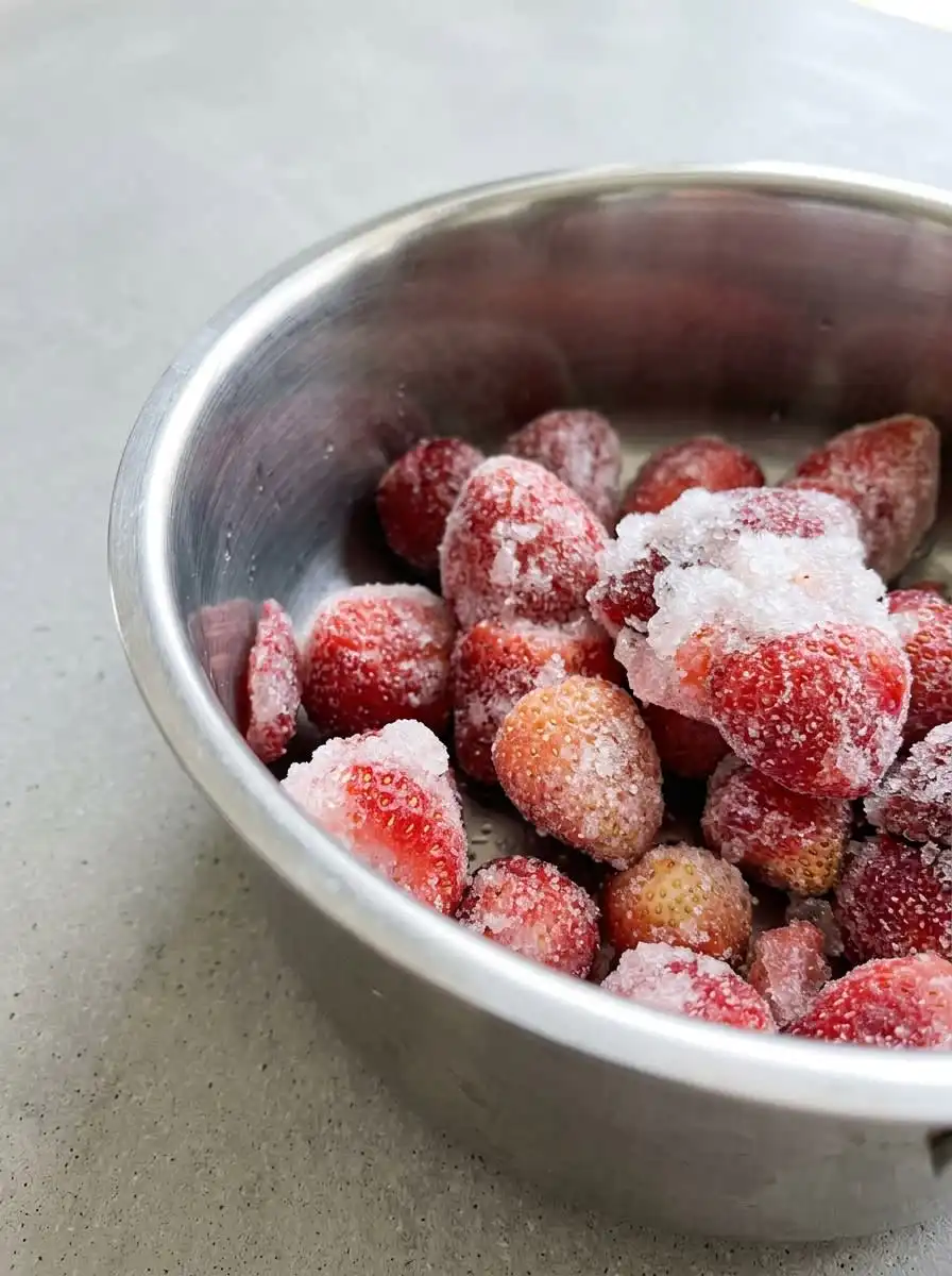 Pouring batter into a pan of hot oil to make Strawberry Topped Funnel Cake.