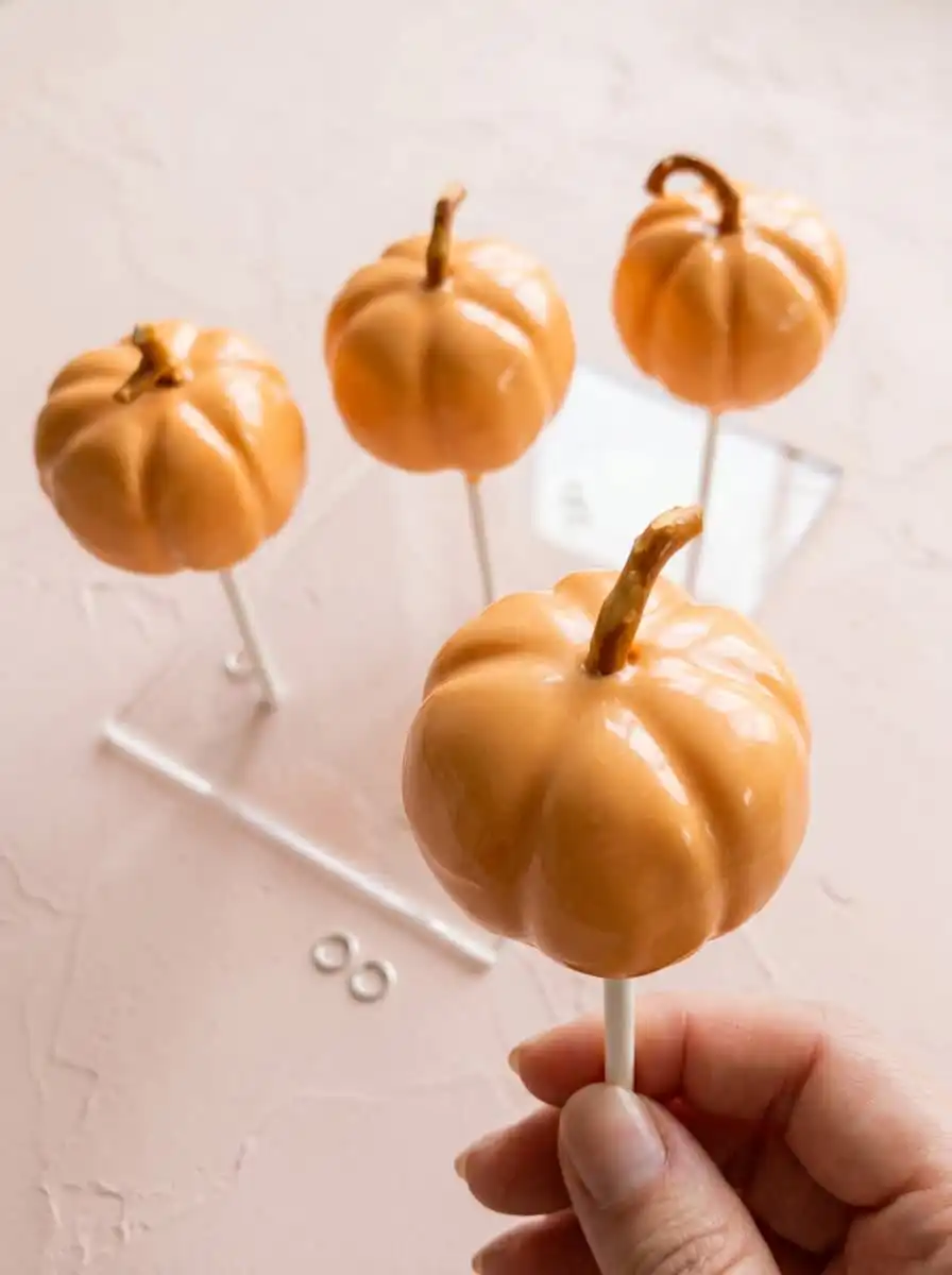 Classic Pumpkin Cake Pops 16 A beautiful display of Classic Pumpkin Cake Pops standing upright in a jar of coffee beans.